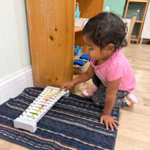 Toddler playing with xylophone